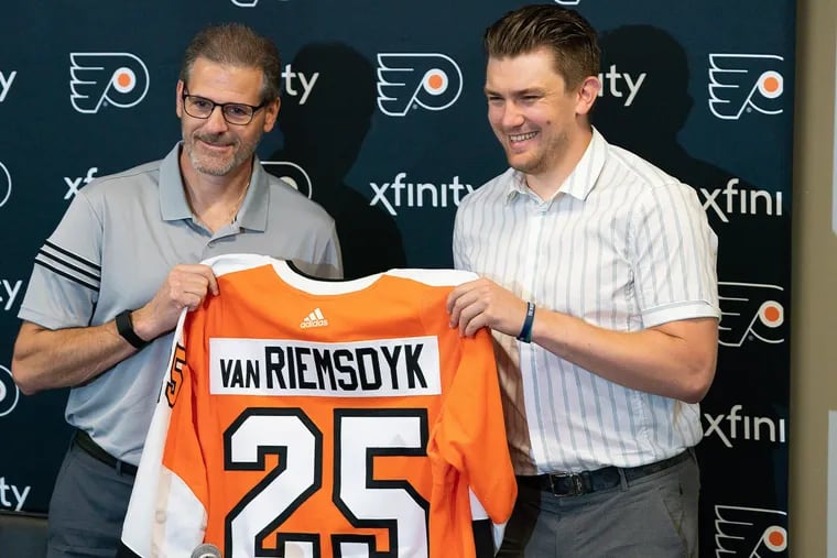 Flyers general manager Ron Hextall (left) and James van Riemsdyk shown during a July news conference to welcome the left winger back to the team.