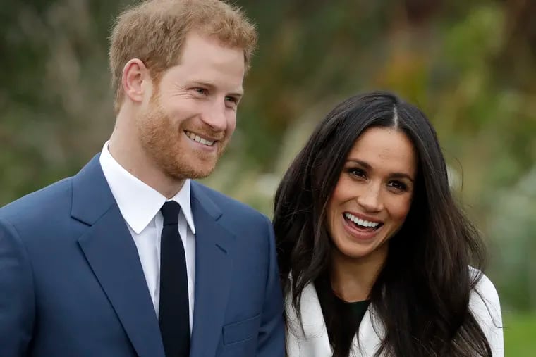 In this Monday Nov. 27, 2017 file photo, Britain's Prince Harry and his fiancee Meghan Markle pose for photographers during a photocall in the grounds of Kensington Palace in London. The British royal family is wrestling with the future roles of Prince Harry and his wife Meghan.