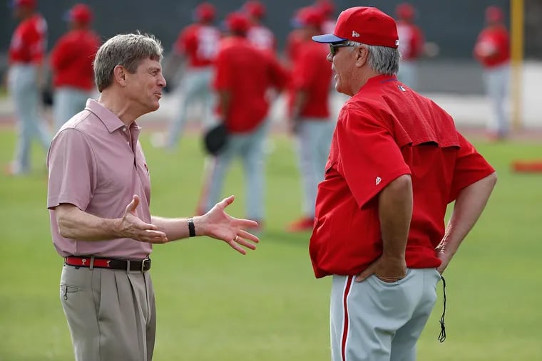 Former Phillies manager Pete Mackanin (right) talks with managing partner John Middleton in spring training. Mackanin didn't have his contract renewed Friday.