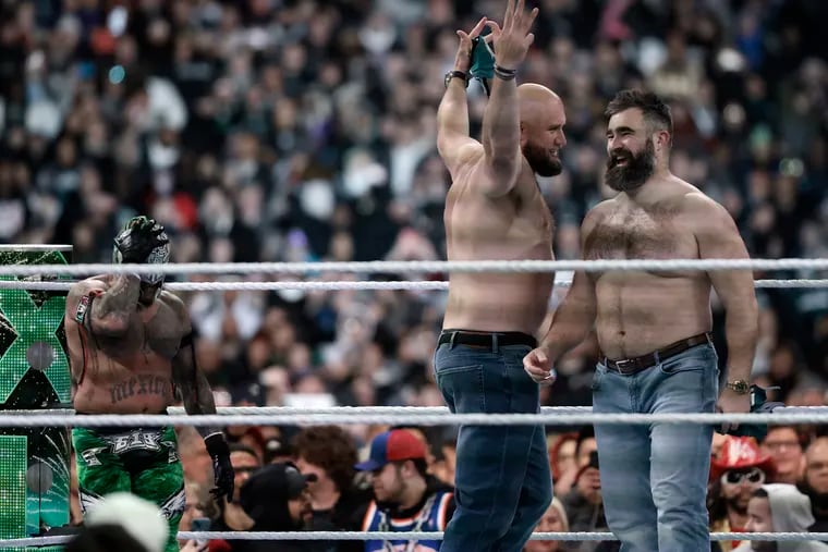Eagles tackle Lane Johnson and former center Jason Kelce appear in the ring during WrestleMania 40 at Lincoln Financial Field on Saturday night.