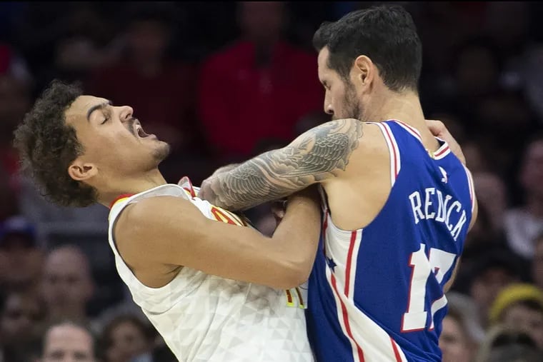 The Sixers' JJ Redick (right) and the Hawks' Trae Young battle.