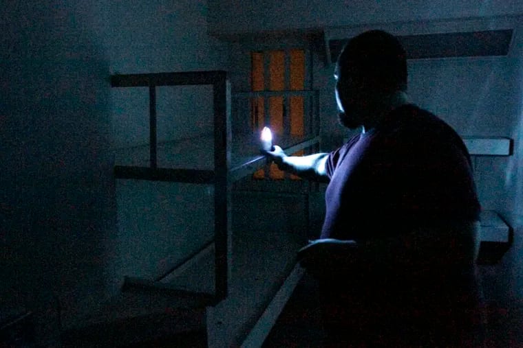 Doug Hogate Jr. places a motion sensor in a cell while searching for paranormal activity at the former Gloucester County Jail. His Salem County group was looking for signs of lingering energy.