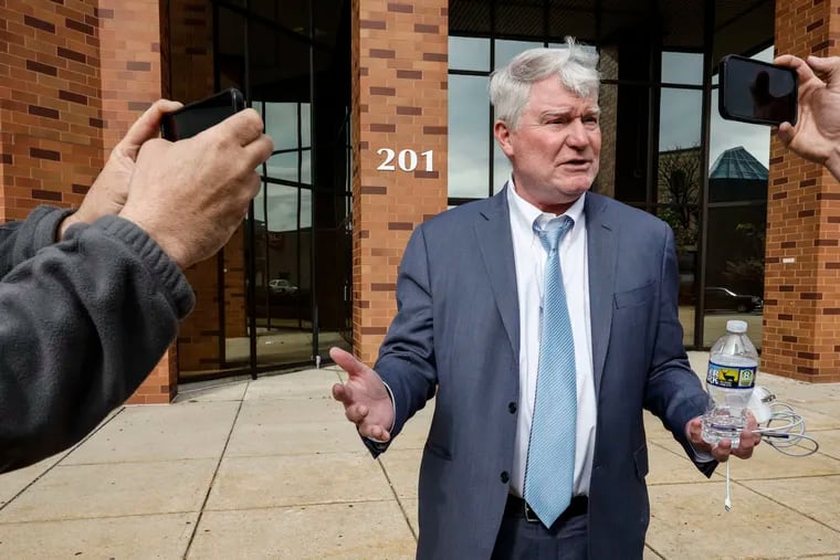 Testimony began Wednesday in the extortion trial of former labor leader John Dougherty, shown here leaving the Reading federal courthouse and talking to reporters.