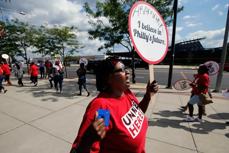 Josie Bethea, a special event banquet server with Aramark at Lincoln Financial Field, walks with large group of protesters at Citizens Bank Park on Thursday.