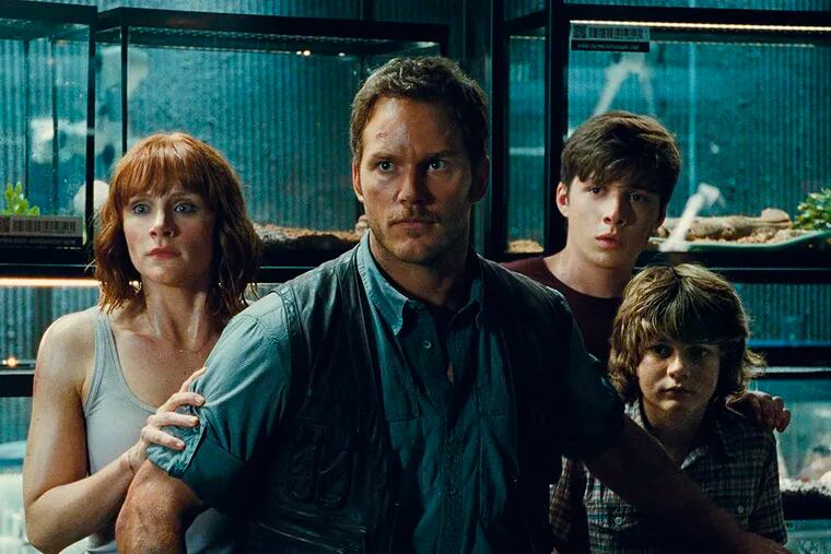 Bryce Dallas Howard, left, as Claire, Chris Pratt as Owen, Nick Robinson as Zach, and Ty Simpkins as Gray, in a scene from the film, "Jurassic World," directed by Colin Trevorrow, in the next installment of Steven Spielberg's groundbreaking "Jurassic Park" series. ( Universal Pictures / Amblin Entertainment via AP )