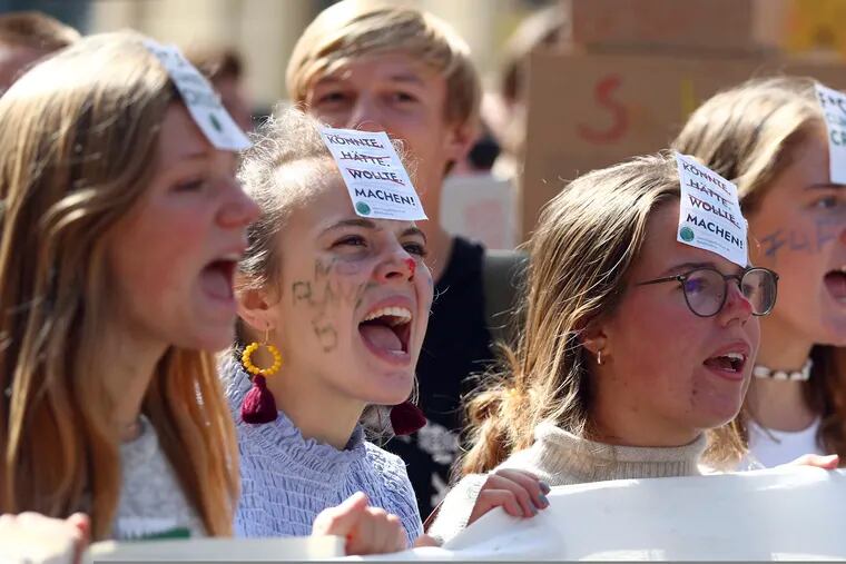 Young women attend a "Fridays For Future" rally in Munich, Germany, Friday, Sept. 20, 2019. Protests of the 'Fridays For Future' movement against the increase of carbon dioxide emissions are planned Friday in cities around the globe. In the United States more than 800 events were planned Friday, while in Germany more than 400 rallies are expected.