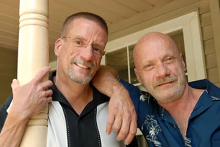 Jim Vokoun (left), 48, with partner Colin Robinson, 53, at their home in Holland, Bucks County. Vokoun, who has had HIV for years, has seen a major change since starting a new drug.