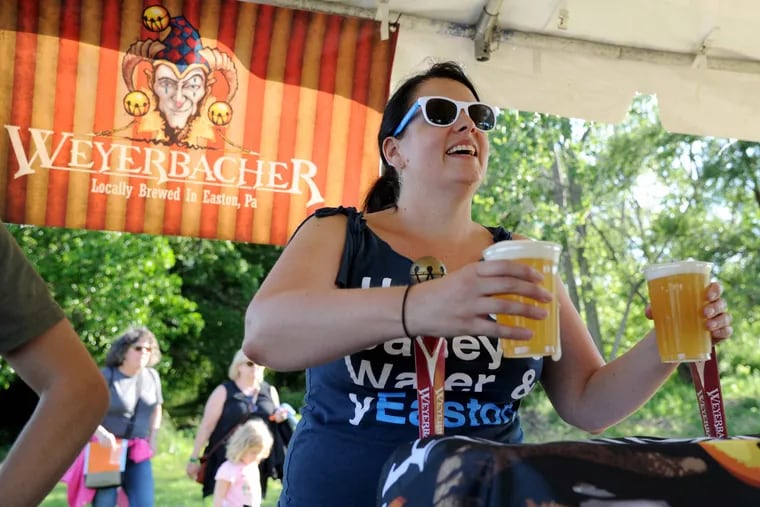 Christina Dowd, the events manager at Weyerbacher Brewing Company, serves up her WIT and IPA#1 at the Bartram’s Garden Community Boathouse on the Schuylkill River.