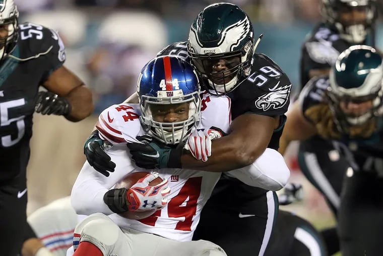 DeMeco Ryans stops the Giants' Andre Williams.
