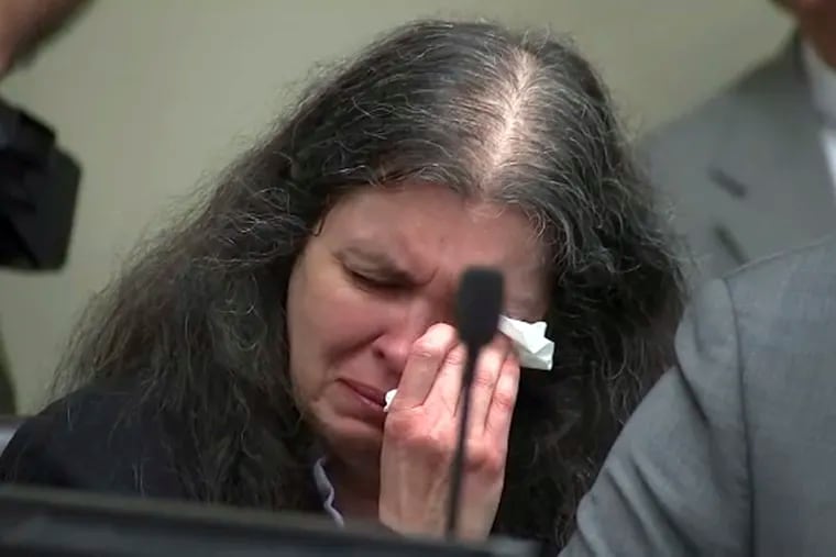 In this photo from video by KABC-TV, Louise Turpin sobs and dabs her eyes as one of her children speaks during a sentencing hearing Friday, April 19, 2019, in Riverside, Calif. David and Louise Turpin, who pleaded guilty to years of torture and abuse of 12 of their 13 children, have been sentenced to life in prison with possibility of parole after 25 years. (KABC-TV via AP, Pool)