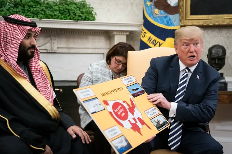 President Trump displays posters as he talks with Saudi Crown Prince Mohammad bin Salman during a meeting in the Oval Office at the White House on March 20, 2018 in Washington, DC.