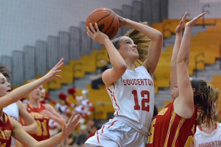 Souderton’s Megan Walbrandt ,12, puts up a shot between Haverford defenders during first half action in the girls District 1 Class 6A playoff contest at Souderton Area High School on Wednesday February 21,2018.