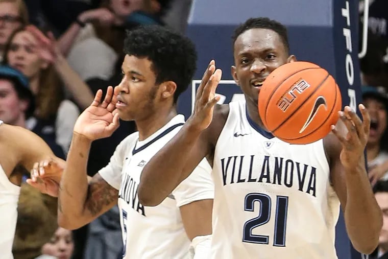 Dhamir Cosby-Roundtree (right) and Jahvon Quinerly celebrate Villanova's win over Creighton on Wednesday. Cosby-Roundtree has been forced to step up as the Wildcats' primary post player after the departure of Omari Spellman.