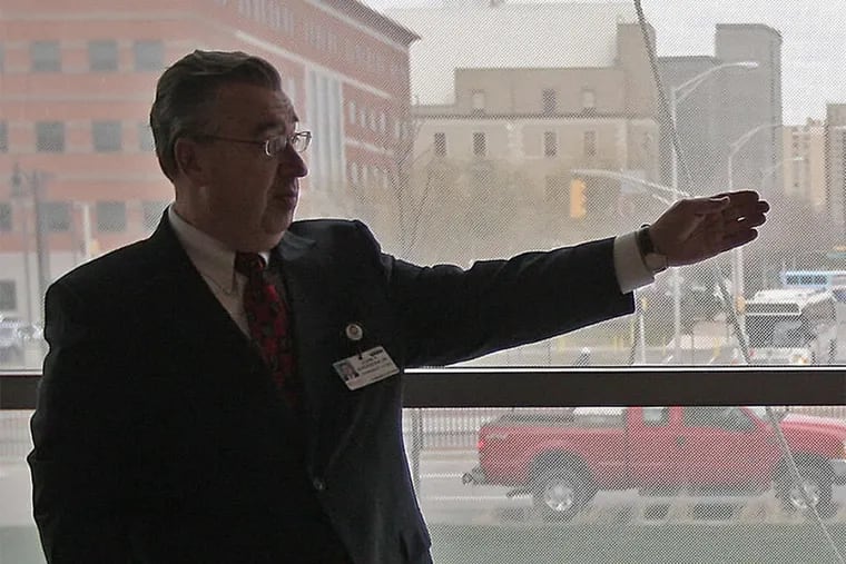 John Sheridan at Cooper University Hospital, where he was CEO, in 2008. A renowned forensic pathologist says there are multiple reasons to think Sheridan and his wife were slain by an intruder.
