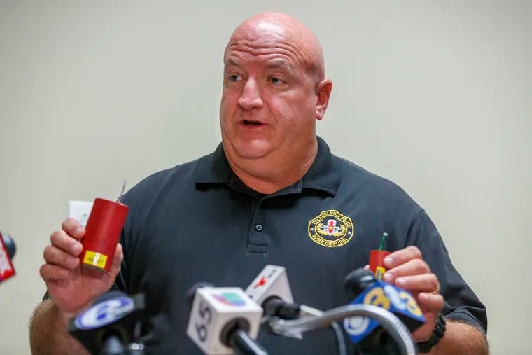 On July 1, 2019, Detective Tim Brooks of the Philadelphia Police bomb squad holds up two illegal explosive devices similar to the one that exploded and injured a 9-year-old girl in her home on Wishart Street.