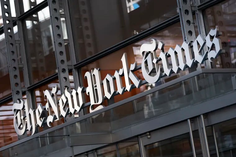 A sign for The New York Times hangs above the entrance to its building, in New York. America's leading news org is making another pitch for conservatives' trust.