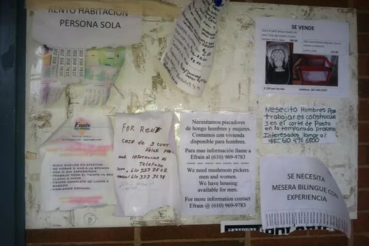 Spanish-language ads posted by employers seeking construction, farm and restaurant workers, landlords offering rental rooms for workers, and used furniture, on a bulletin board outside a Mexican grocery and restaurant near U.S. 13 just south of the Pennsylvania-Delaware state line, 2016