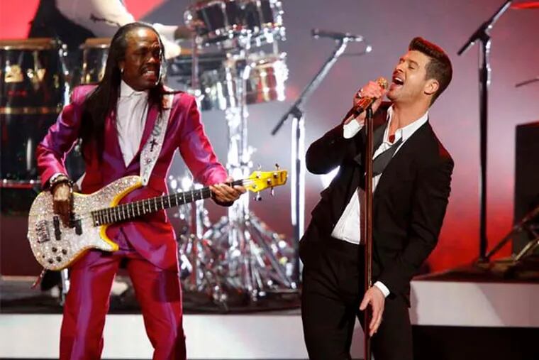 Robin Thicke, right, performing in Los Angeles in December. At the Susquehanna Bank Center on Thursday, his hits were funky and furious; the ballads defined where he is.
