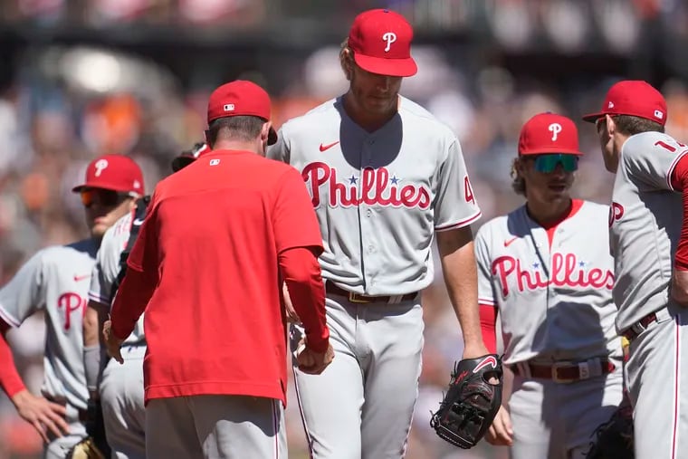 Philadelphia Phillies interim manager Rob Thomson, foreground, takes the ball from pitcher Noah Syndergaard while making a pitching change during the fifth inning of a baseball game against the San Francisco Giants in San Francisco, Saturday, Sept. 3, 2022. (AP Photo/Jeff Chiu)