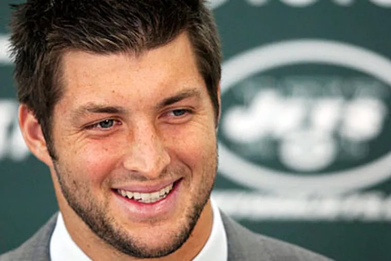 Tim Tebow was traded to the Jets after Peyton Manning signed with the Broncos. (Mark Lennihan/AP)