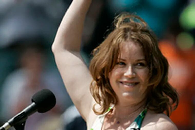 Actress Molly Ringwald waves to the crowd after singing the national anthem prior to the Detroit Tigers-Baltimore Orioles game in Detroit yesterday. The Tigers prevailed, 3-2.
