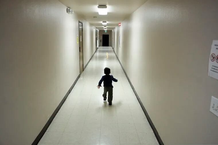 FILE - In this Dec. 11, 2018, file photo, an asylum-seeking boy from Central America runs down a hallway after arriving from an immigration detention center to a shelter in San Diego. Lawyers for eight immigrant families separated under Trump administration policy filed claims Monday, Feb. 11, 2019, against the U.S. government demanding $6 million each in damages for what they describe as lasting trauma.