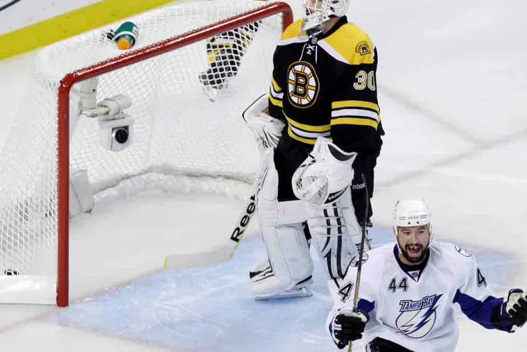 Tampa Bay's Nate Thompson celebrates a goal by Adam Hall 13 seconds into Game 2 of the Eastern Conference finals in Boston. Tim Thomas is the beaten Bruins goaltender.
