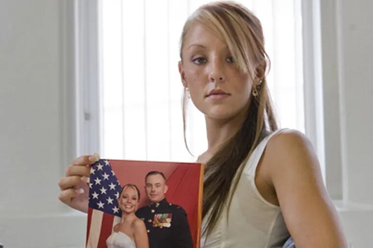 Heather Loomis, 25, and a former Marine, holding picture of her father, says "everyone just looks at you kind of differently." (Jessica Griffin / Daily News)