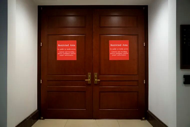 Bright red signs alert non-authorized personnel at the entrance to the House SCIF, the Sensitive Compartmented Information Facility, located three levels beneath the Capitol, in 2019.