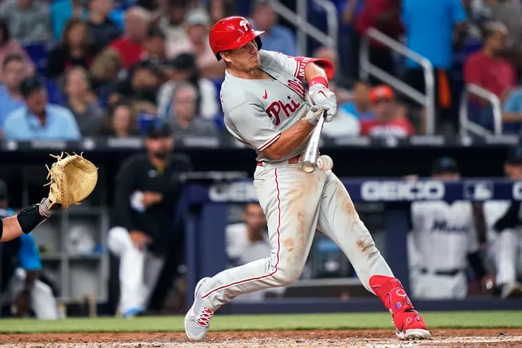 Phillies catcher J.T. Realmuto hits a single during the fifth inning against the Marlins in Miami.