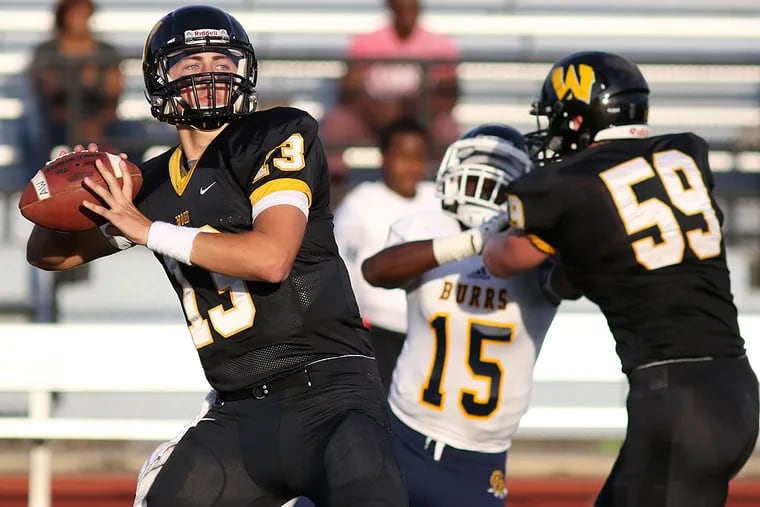 Archbishop Wood's Anthony Russo (13) drops back to pass the ball.