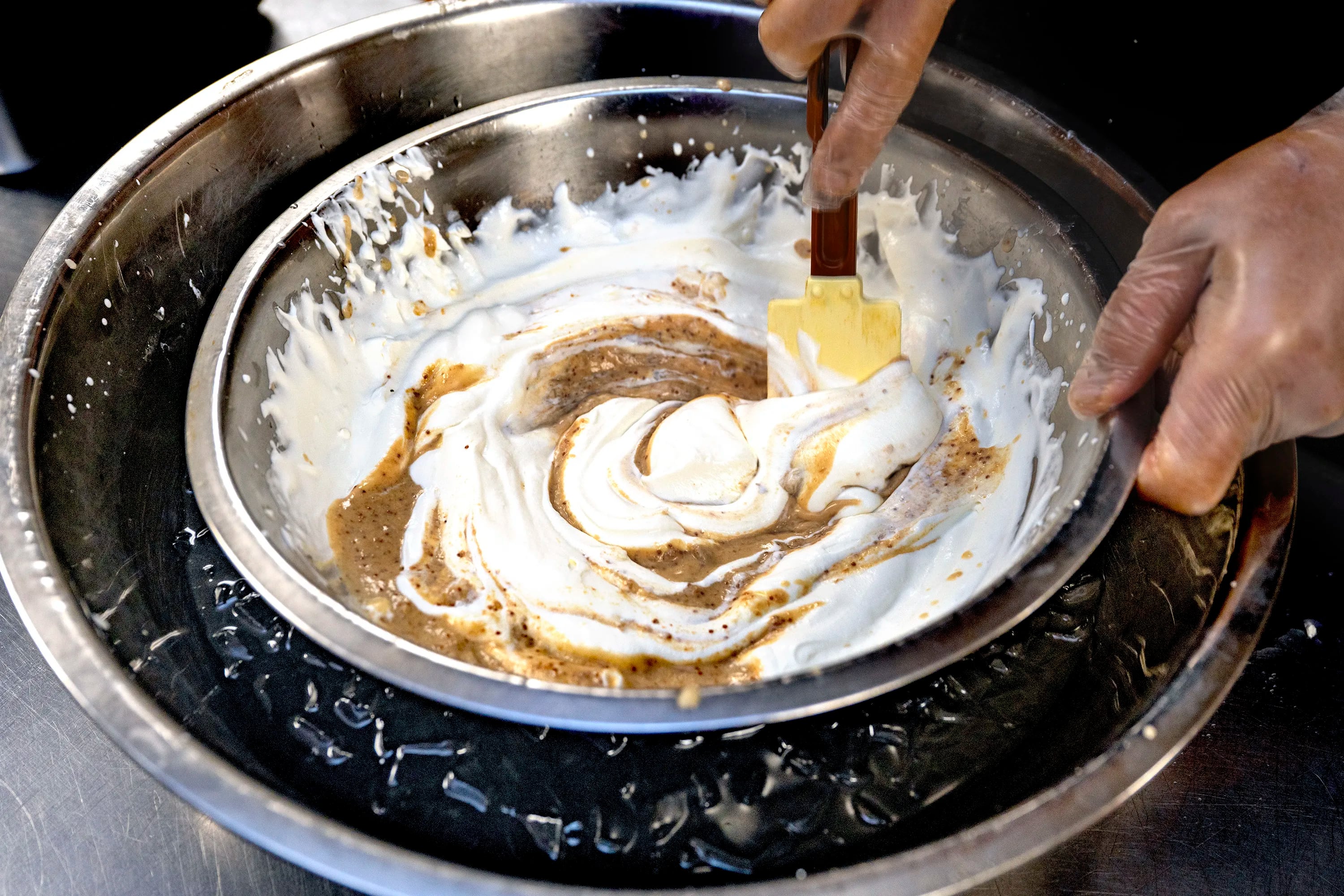 Rakesh Ramola stirs the fig mixture into pan with whipped cream as he makes anjeer (fig) kulfi at his Indeblue restaurant in Cherry Hill.