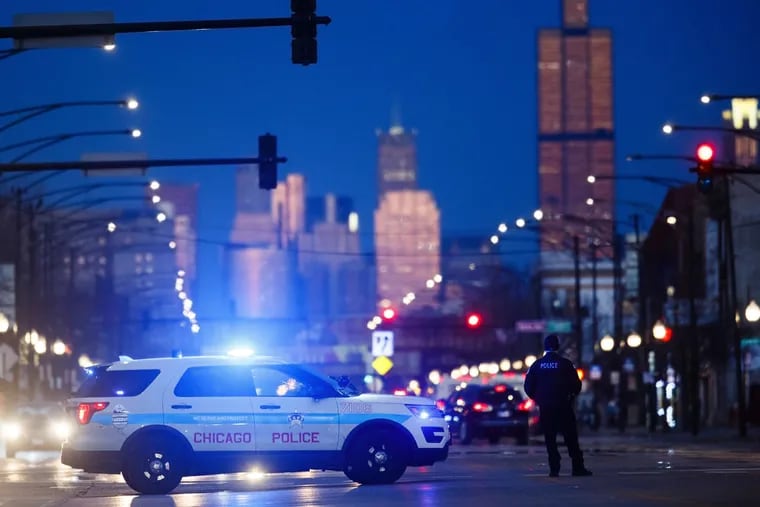 Police investigate the shooting of three people near the 5000 block of West Madison Street in Chicago on March 26, 2019.