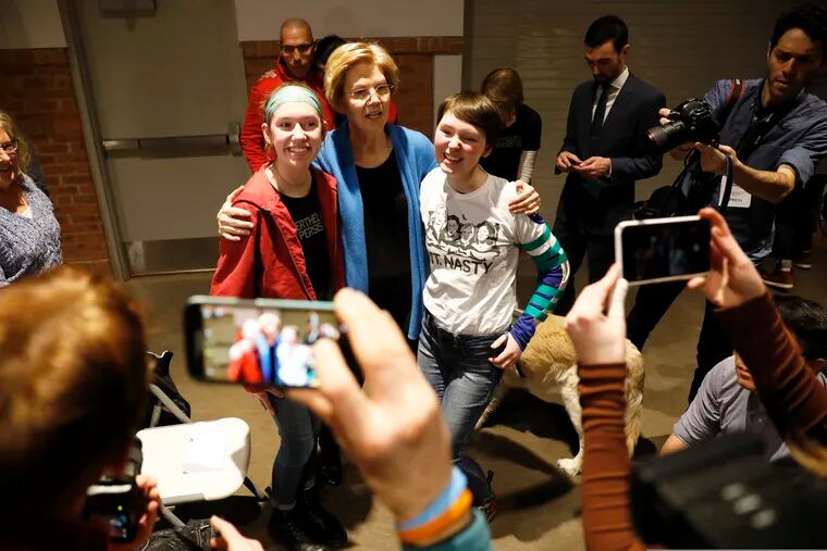 Sen. Elizabeth Warren, D-Mass., poses for a photo with a local residents during an organizing event, Sunday, Feb. 10, 2019, in Cedar Rapids, Iowa.