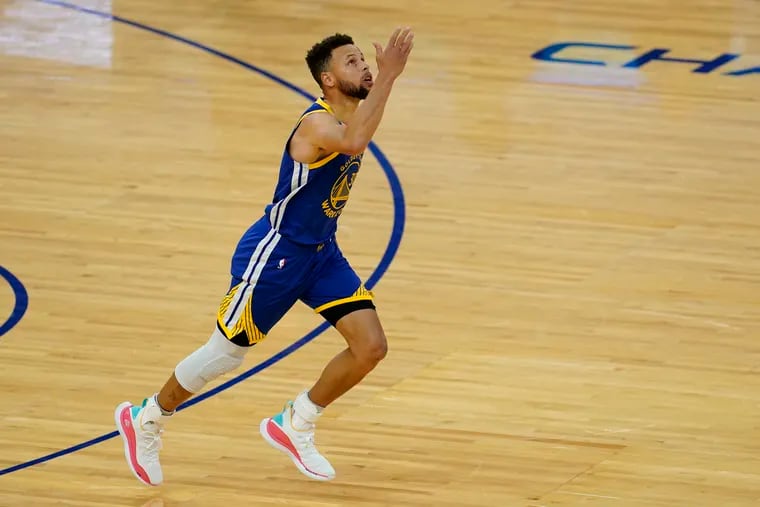 Golden State Warriors guard Stephen Curry gesturing after scoring against the Denver Nuggets to pass Wilt Chamberlain and become the franchise's all-time leading scorer on Monday.