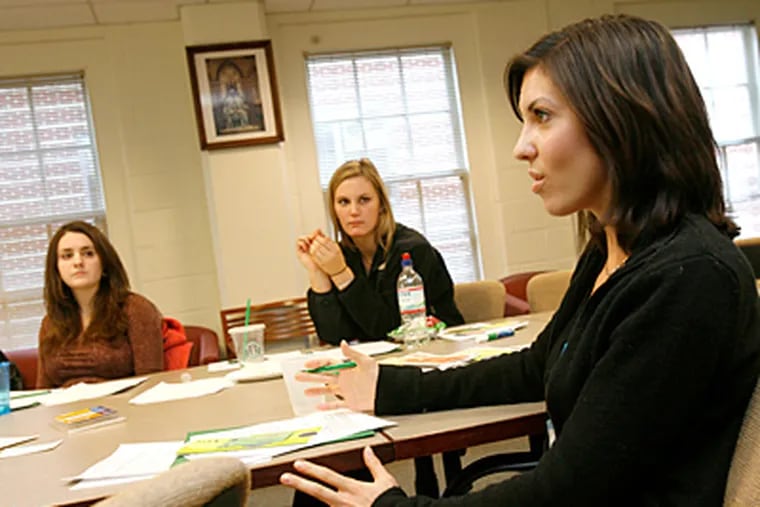 A group of students gather for training in how to recognize and help classmates who are suicidal or are having other mental health problems. Students Rebecca Asher, left, Kelcie Pinick, center, and Kelly Miskill, right, take part in a discussion. (Charles Fox / Staff Photographer )