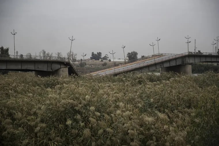 The Jamhuriya bridge over the Tigris River sits destroyed in Mosul, Iraq, in November 2018. More than two years after the brutal fighting that liberated the city from ISIS, Mosul has faced a slow and painful path back to normalcy.