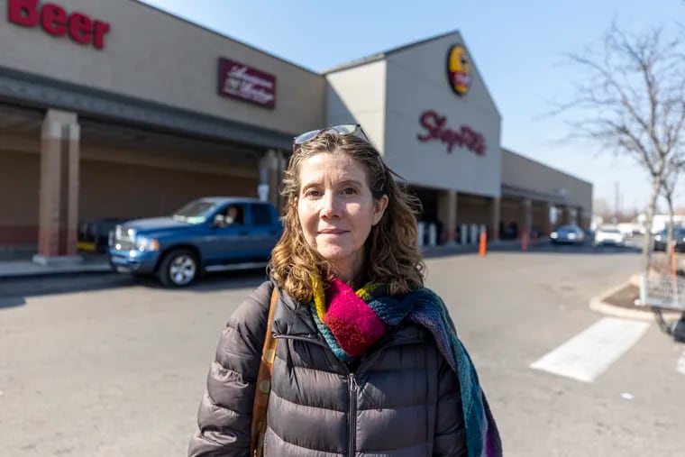 Michelle Schmitt, of Germantown, Pa., poses for a portrait in front of a Shop Rite in West Philadelphia, Pa., on Tuesday, Feb. 27, 2024. Schmitt is a senior policy analyst for the Reinvestment Fund.