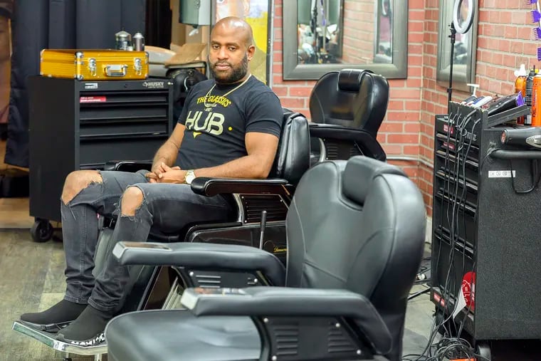 Ulysses Williams sits in one of the barber chairs of his Classic Hub Barber Shop in South Philadelphia.