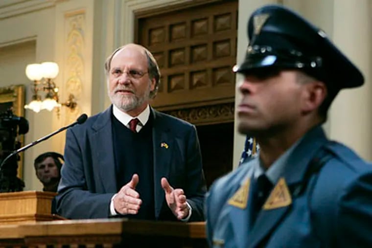 As a state trooper stands nearby, New Jersey Gov. Jon S. Corzine delivers his budget address on Tuesday. (AP Photo/Mel Evans)