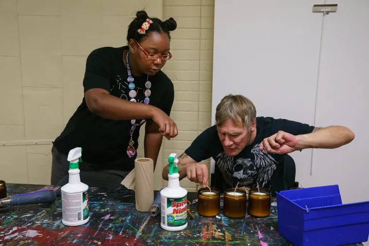 Kai Oceans (left), workshop facilitator, and Sean Toal, a resident, make candles as part of a gift box business that brings money to Project HOME.