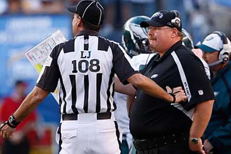Eagles coachAndy Reid discusses yet another penaltywithagame official. ( Ron Cortes / Staff Photographer )