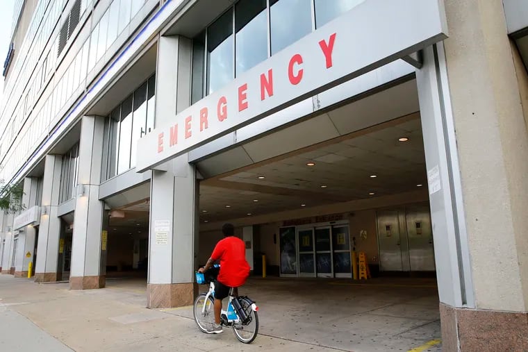 A cyclist rides past Hahnemann University Hospital's emergency entrance on Vine Street on Friday.
