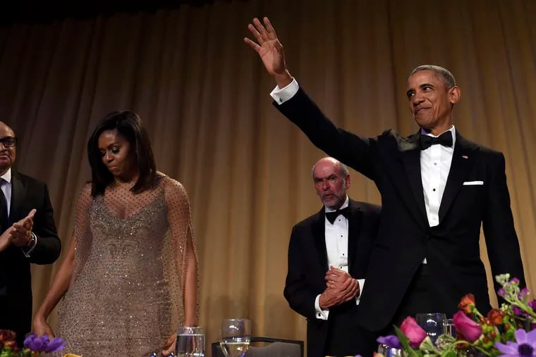 President Obama waves after speaking at the annual White House Correspondents' Dinner at the Washington Hilton, where he was joined by comedian Larry Wilmore (left), Michelle Obama, and Jerry Seib of the Wall Street Journal.