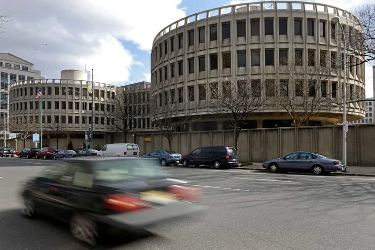 FILE – In this Feb. 27, 2013, file photo, a car drives past the Philadelphia Police Department’s headquarters building, which opened in 1963 and is known as the Roundhouse, in Philadelphia. (AP Photo/Matt Rourke, File)