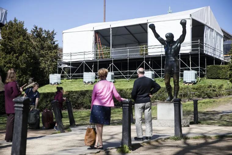 Tourists visit the Rocky statue during construction of the NFL draft stage in April. Now, it is the statue that will be closed to the public.