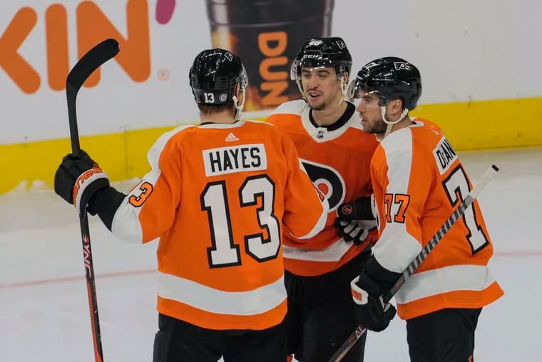 Flyers Morgan Frost (center) celebrates one of his two goals against the Montreal Canadiens on Tuesday.