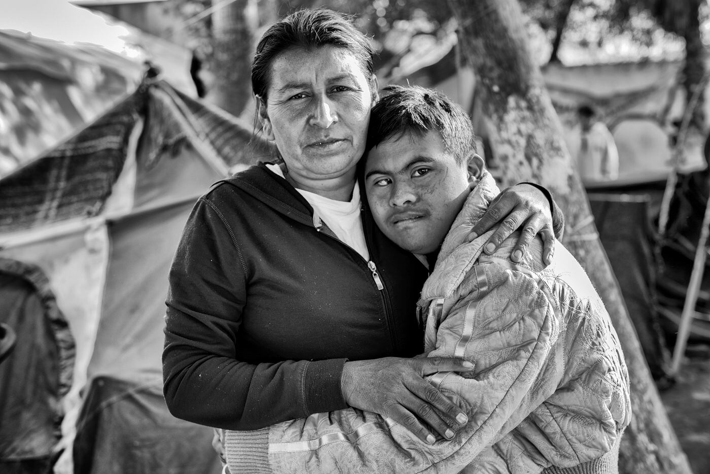 A mother and her son, who has Down's syndrome, pose for a photo during the migrant caravan to the Mexican border.