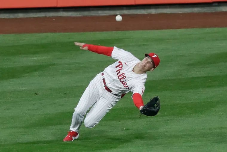 Phillies center fielder Mickey Moniak falls down as he catches a fly ball in the second inning Monday night at Citizens Bank Park.