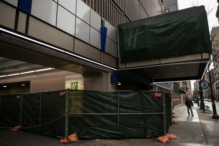 The Holiday Inn Express at 13th and Walnut in Center City is barricaded on Saturday, March 28, 2020. The city turned the hotel into Philadelphia’s first coronavirus quarantine site, and has used it to house homeless people who test positive for the virus.